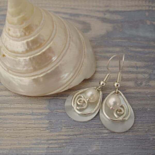 Silver plated earrings with tear drop shaped shell pearl, hammered silver plated wire detail and a single freshwater cultured pearl