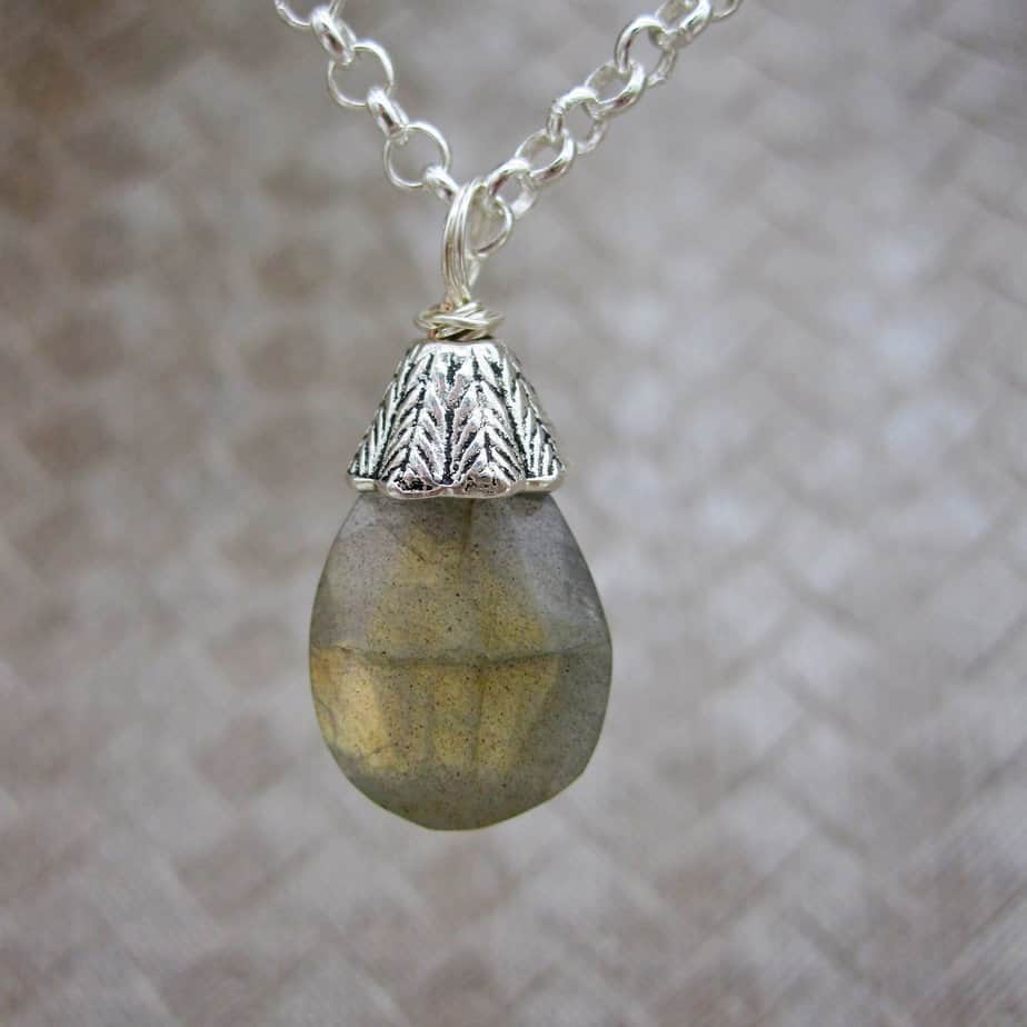 Designed and created in the Isle of Skye, this pendant necklace features a labradorite gemstone drop with silver plated bead cap. On 18 inch silver plated chain.