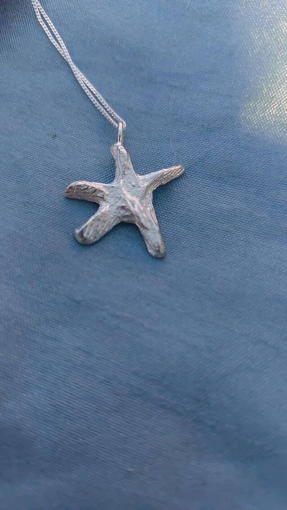Silver star fish cast in cuttle fish bone - handmade by Designs on Benbecula