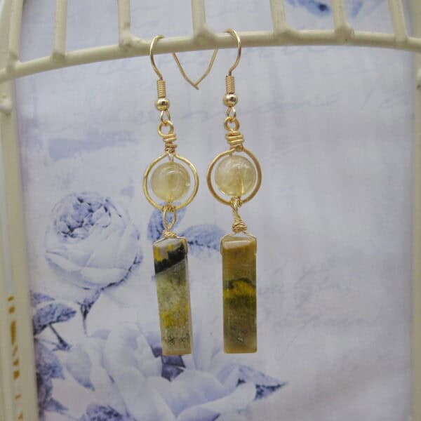 Drop earrings. Citrine round bead with halo of gold coloured wire. With column of bumblebee jasper hanging underneath. Gold plated ear wires.