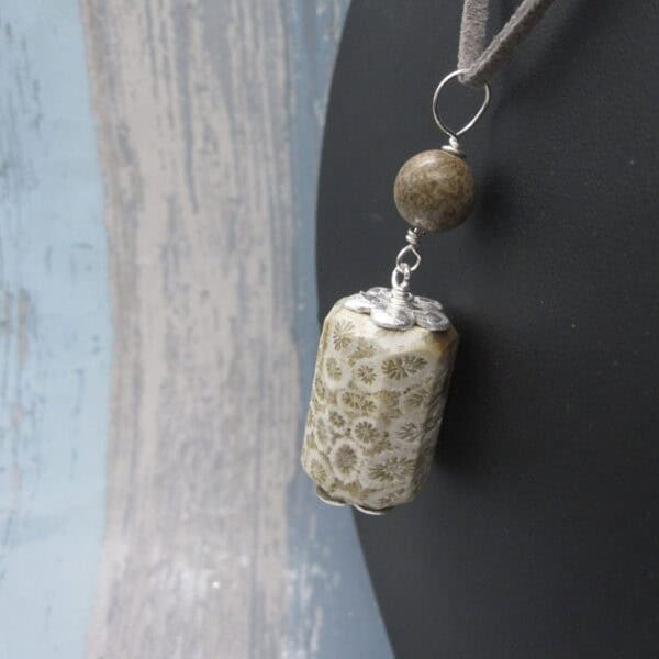 Fossil jasper pendant with simple silver plated bead caps and a single focal bead of deep brown jasper on a grey leather cord. Designed and created in the Isle of Skye.