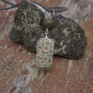 Fossil jasper pendant with simple silver plated bead caps and a single focal bead of deep brown jasper on a grey leather cord. Designed and created in the Isle of Skye.