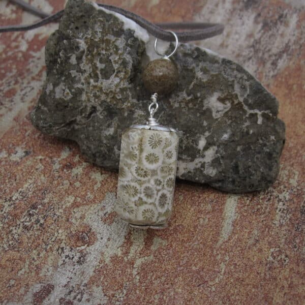 Fossil jasper pendant with simple silver plated bead caps and a single focal bead of deep brown jasper on a grey leather cord. Designed and created in the Isle of Skye.