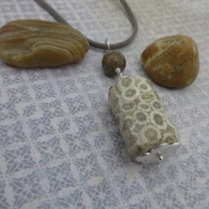 Fossil jasper pendant with simple silver plated bead caps and a single focal bead of deep brown jasper on a grey leather cord. Designed and created in the Isle of Skye.
