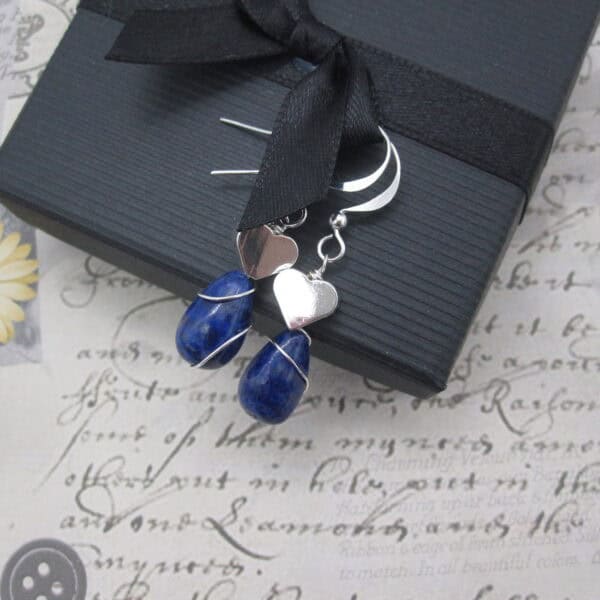 Earrings with silver plated heart and lapis lazuli.