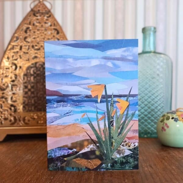 A photograph of a greetings card featuring daffodils by the sea