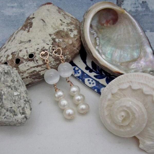 Drop earrings with single white selenite round and three pearls. Rose gold plated in sterling silver with heart detail.