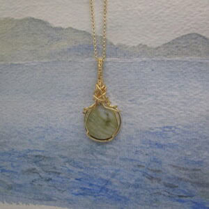 circular skye marble pendant with gold plated wire wrap and chain. Designed and created in the Isle of Skye by Indigo Berry.